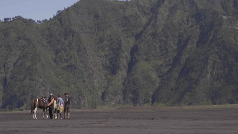 Malang-Indonesia, Maret 2020;  4K footage. Tourist groups are discussing with tour guides on Bromo Mountain. 