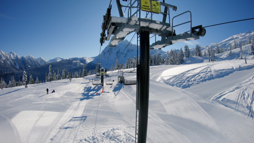 Mt Baker Chairlift Ride Reveal of Mt Shuksan.  Slow motion ski lift view of bluebird winter day at extreme sports resort