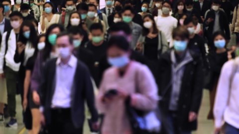 Slow motion of unrecognized people wearing medical face masks at metro in Hong Kong. Coronavirus concept
