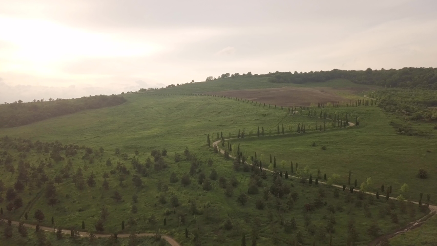 road uphill at sunset from above