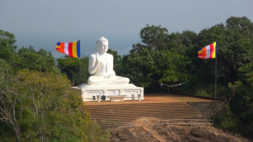 Sculpture of a sitting Buddha (White Buddha) on a Sunny day. The mango plateau, Mihintale. Sri Lanka