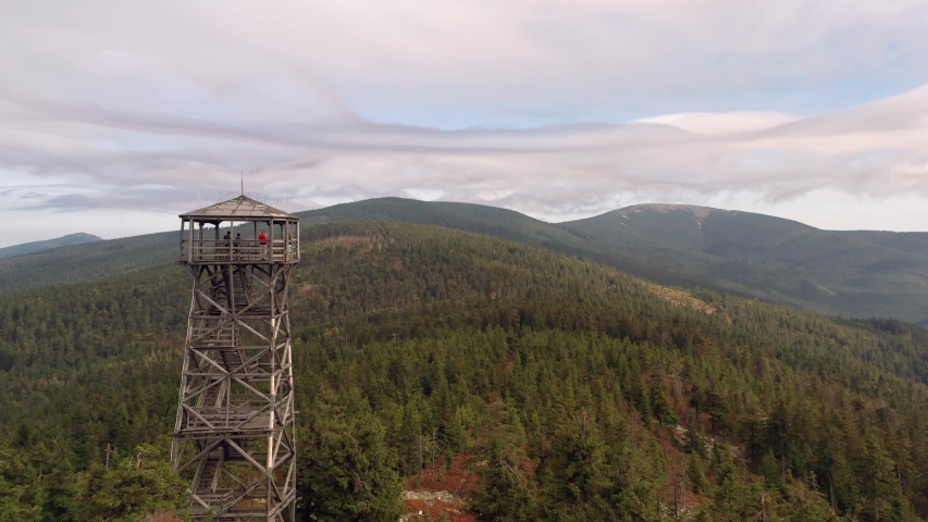 Drone shot of watchtower on top of the hill with Czech countryside in the background