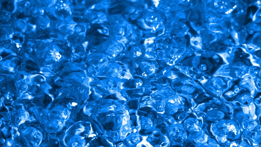 Boiling Bright Blue Liquid. Intense seething. Slow motion boiling water, painted Bright Blue