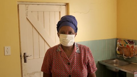 Johannesburg, South Africa. 24 March 2020. Portrait of a black woman wearing a protective mask during the Coronavirus pandemic. Nation to begin 21 day lockdown as it braces for more Covid-19 cases.