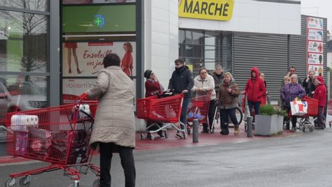 FRANCE: Covid-19 crisis people rushing to supermarket to buy full carts of food. very long waiting line of french old people preparing weeks of containment at home. Angers Lock down 