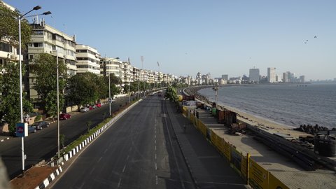 Mumbai, India: March 22, 2020: Deserted Marine drive and surrounding area on first day of lock down in Mumbai due to Covid 19 pandemic. Corona virus outbreak in third stage in Mumbai.