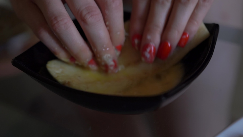 Girl in home clothes is preparing food wipe. eggplant in plate with beaten egg, yolk. Puts, rolls breading flour. Proper nutrition vegetables vegan. healthy nutrition Chop grease