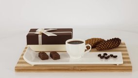 White mug with black coffee with sweets on table background. *UHD.