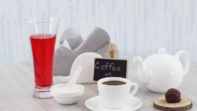 Cup of black coffee with juice glass and sweets on wooden table background. *UHD.