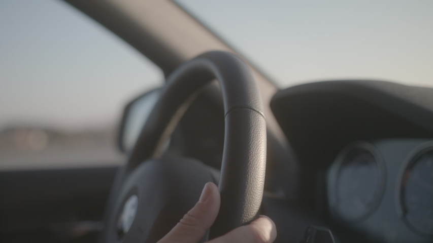 Driving a luxurious BMW car during sunset