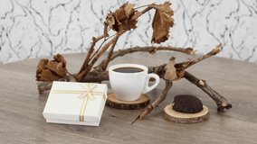Coffee cup with cookies and gift box on wooden table background. *UHD.