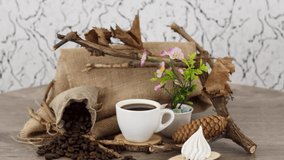 Coffee cup with dried twigs on wooden table background. *UHD