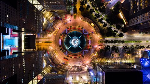 4K Hyperlapse time-lapse of car traffic transport at roundabout fountain of wealth in Singapore, drone aerial top view, fly upward. Transportation technology, city life, Asia travel landmark concept
