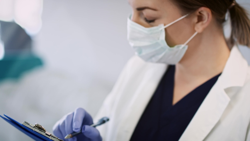 Video of doctor in face mask making a medical exam