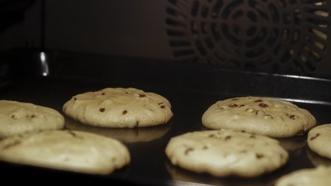 Baking of chocolate chip cookies in oven. Melting dough and chocolate turning into fresh delicious and homemade treat. Time lapse video