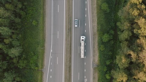 Drone rises. Gasoline tanker, Oil trailer, truck on highway. Aerial top view. Truck on a cinematic road aerial shot
