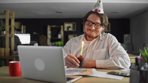 Alone businessman celebrating birthday in the office