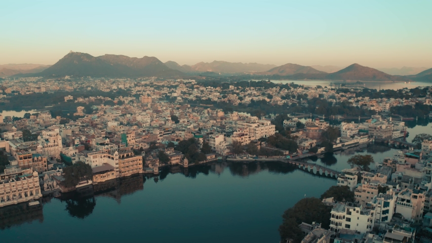 Beautiful ariel city view from lake Pichola, Udaipur (City of lakes) Rajasthan, India, 4k Drone shot.