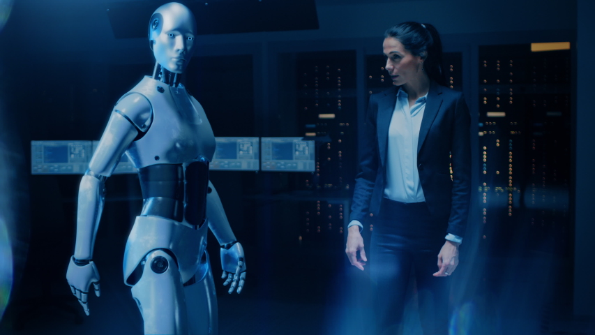 Beautiful, Confident Female Engineer Touching Hands with Humanoid Robot Activating Collaboration, Teamwork Protocol. Computer Artificial Intelligence Concept: People and Robots Working Together Royalty-Free Stock Footage #1048999426