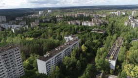 The abandoned city of Pripyat. Destroyed buildings. Overgrown streets of the city. Chernobyl Video from the drone.