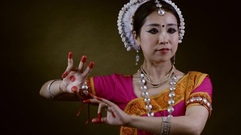Odissi India traditional dancer performing in studio, 4k slow motion