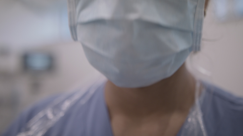 Closeup of Nurse in infection room fixing mask. Royalty-Free Stock Footage #1049010826