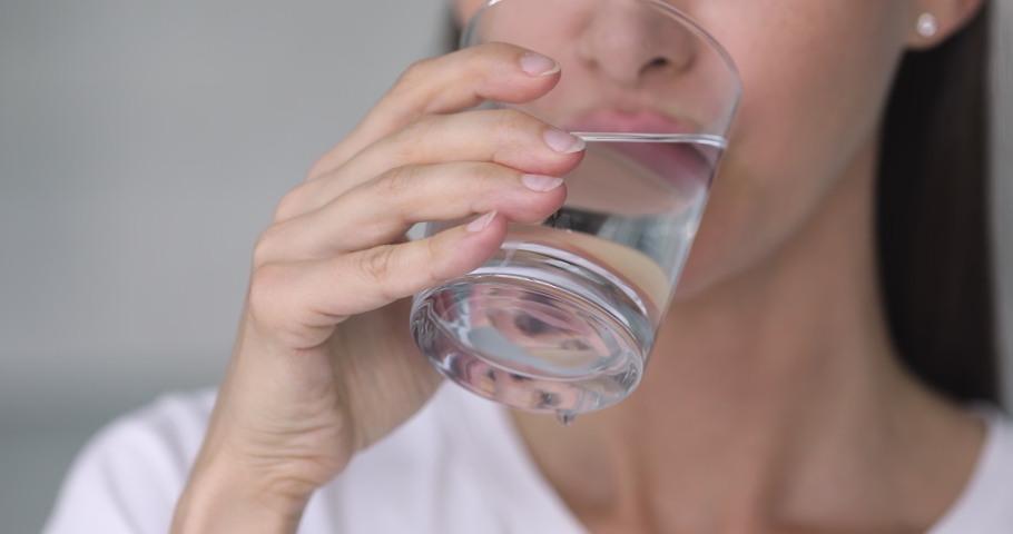 Close up young woman drinking glass of fresh pure stilled water, enjoying daily morning healthcare routine. Thirsty 30s lady refreshing herself, keeping nutrition weight loss diet for healthy body. Royalty-Free Stock Footage #1049015212