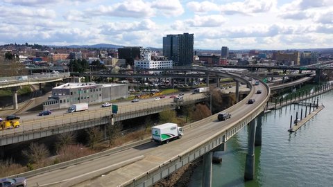 CIRCA 2010s - High angle establishing shot of freeway traffic and Willamette River in Portland, Oregon.