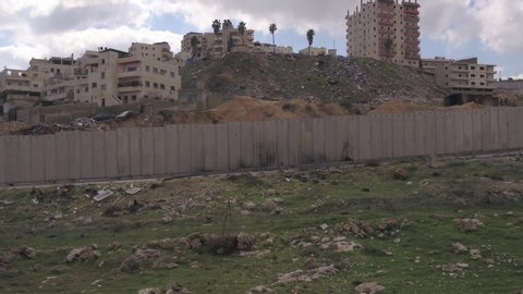 Drone footage of The Israeli West Bank barrier or wall is a separation barrier in the West Bank or along the Green Line. Israel calls it a security barrier against terrorism, while Palestinians call i