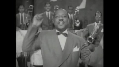 CIRCA 1941 - Count Basie starts off his band on "Air Mail Special" while couples dance.
