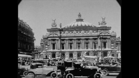 CIRCA 1927 - Cars are seen driving towards the Paris Opera House in Paris, France.