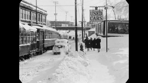 CIRCA 1942 - Icicles cling to a frozen streetcar in Ottawa, Canada, as pedestrians pass by on a snowy sidewalk.