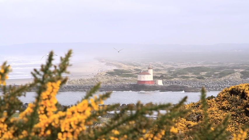 Coquille River Lighthouse in Bandon Oregon on a cloudy and foggy day typical of winter on the coast
