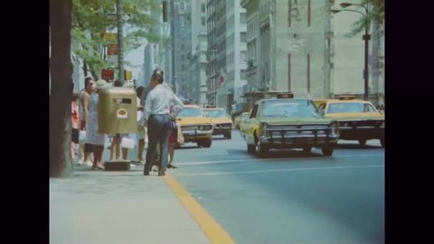 CIRCA 1970s - Taxis, pedestrians, billboards and an adult movie theater are shown in New York.