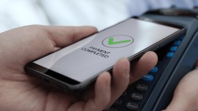 Purchase by cell-phone on electronic payment machine or card reader of supermarket. E-money for deal at cashless wallet of client. Male and female hands with pos-terminal close-up. Employee buys goods - Powered by Shutterstock - Get 15% off with code: PIKWIZARD15