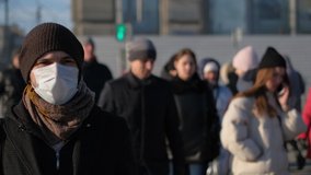European man in face mask city street under Covid-19 pandemic 2021. Europe infected, coronavirus flu epidemic. Human person masked against 2019-ncov corona virus. US people crowd sick with covid 19. - Powered by Shutterstock - Get 15% off with code: PIKWIZARD15