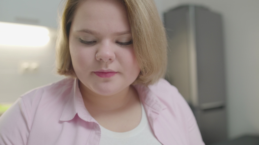 Happy female teenager eating fresh apple, organic nutrition, vitamin C, diet
