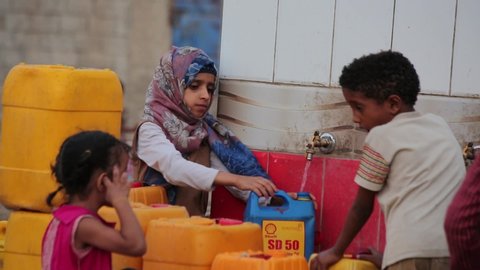 Taiz Yemen - 18 Mar 2019: Children fetch water due to the water crisis and the difficult living conditions witnessed by residents of the Taiz city in southern Yemen since the beginning of the war