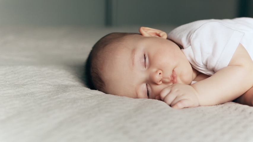 Sleeping cute baby boy on gray blanket | Shutterstock HD Video #1049048227
