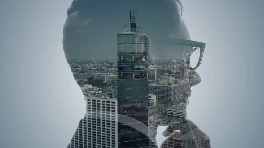 Double exposure of a businessperson and cityscape. | Shutterstock HD Video #1049061571