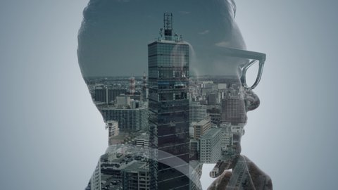 Double exposure of a businessperson and cityscape.