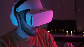 Neon light. Handsome man wearing virtual reality headset. Augmented Reality. Creative man touch something using modern 3D vr glasses indoors. Freelancer student working using VR glasses. Closeup 4K - Powered by Shutterstock - Get 15% off with code: PIKWIZARD15