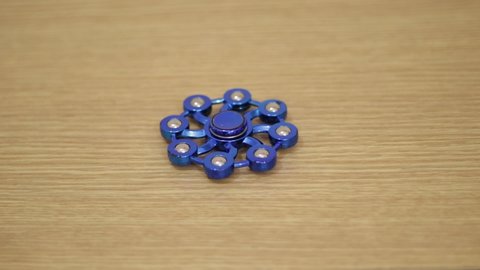Blue color Spinner Spinning on a table
