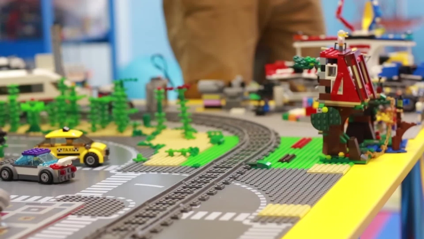 a toy train moves in a circle , twice, on a childrens railway