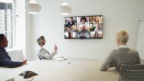 Group Using Video Conferencing technology in office for video call with colleagues abroad - Powered by Shutterstock - Get 15% off with code: PIKWIZARD15