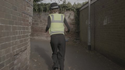 tracking shot of a Policewoman running
