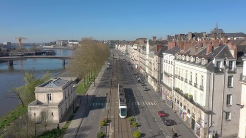 France, Nantes, tramway running in the street, drone aerial view