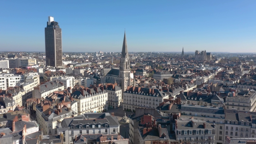 France, Bretagne, Brittany, Nantes, Saint-Nicolas church with Tour Bretagne and Sainte-Croix de Nantes church in the background, drone aerial view | Shutterstock HD Video #1049082901