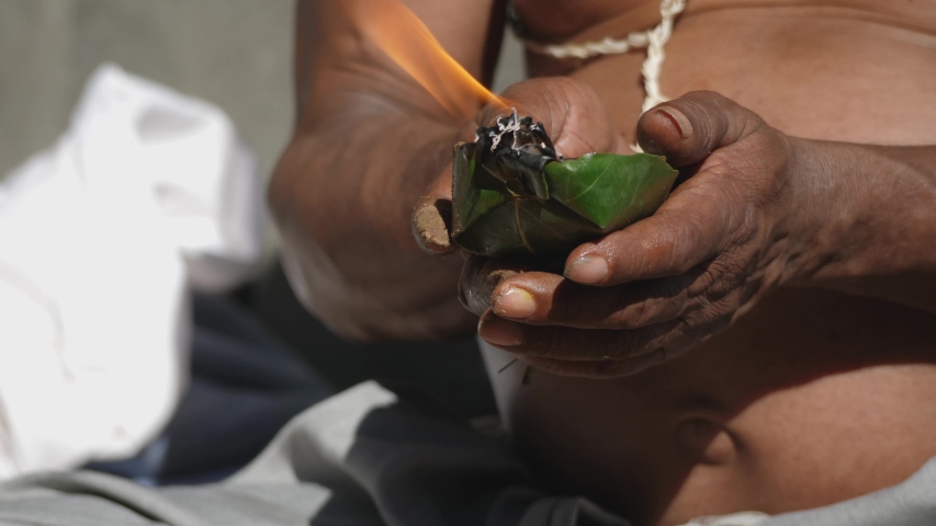 Nepal. Annapurna Circuit. Hindu male with incense burner made out of leaves at a ceremony.
