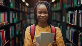 University Library: Smart Beautiful Black Girl Standing Next to Bookshelf Holding and Reading Text Book, Doing Research for Her Class Assignment and Exam Preparations. Authentic Students Study and Suc - Powered by Shutterstock - Get 15% off with code: PIKWIZARD15